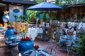 Enjoy al fresco dining amidst lush surroundings and serene water features.