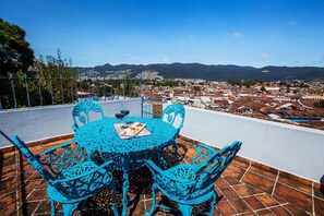 Enjoy a meal on the rooftop with a view of the city and mountains.