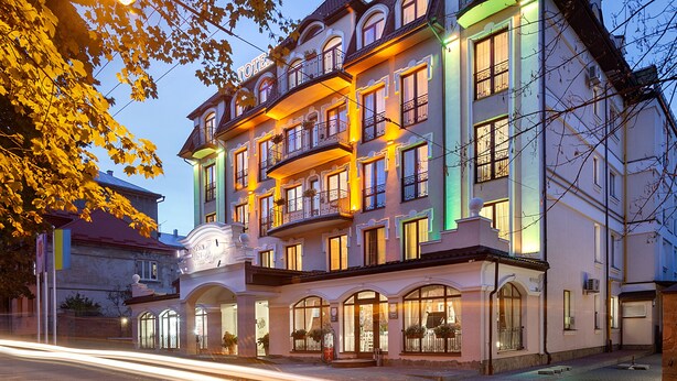 A multi-story hotel with balconies, large windows, and a sign indicating it is a hotel. - Nota Bene Hotel (Lviv)