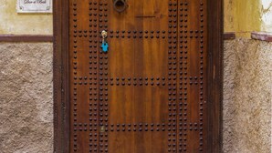 A wooden door with a number '46' and a decorative metal pattern. - Dar El Bali (Fes)