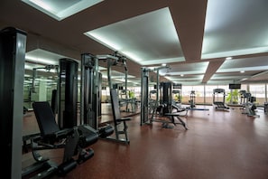 A gym with various exercise machines, mirrors, and a spacious layout. - The Mercer Sukhumvit 4 (Bangkok)