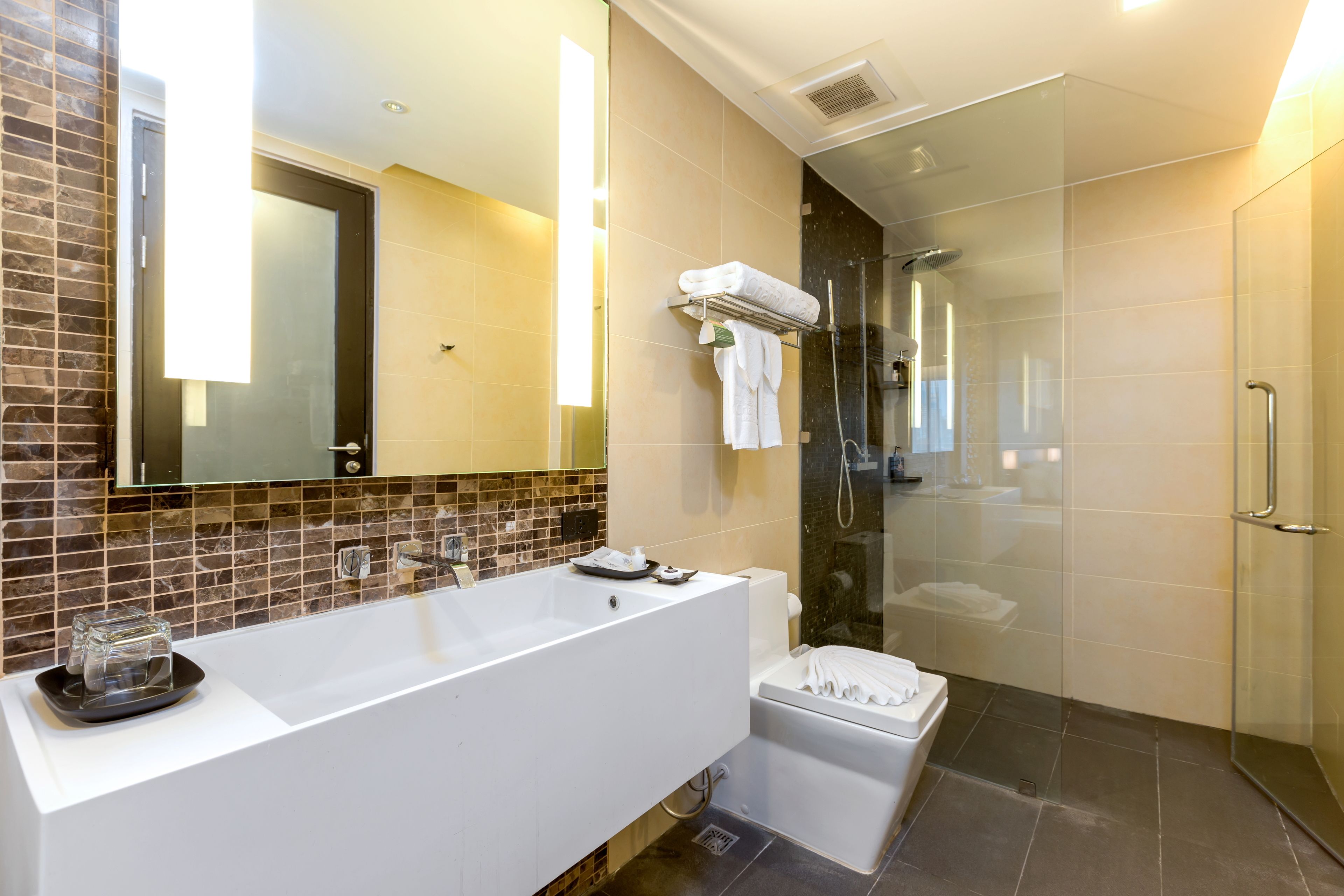 A modern bathroom with a large bathtub, a separate shower area, and a glass-enclosed walk-in shower.