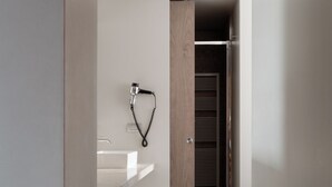 A modern bathroom with a white sink, a towel rack, and a wooden floor. - Posta Design Hotel (Como)