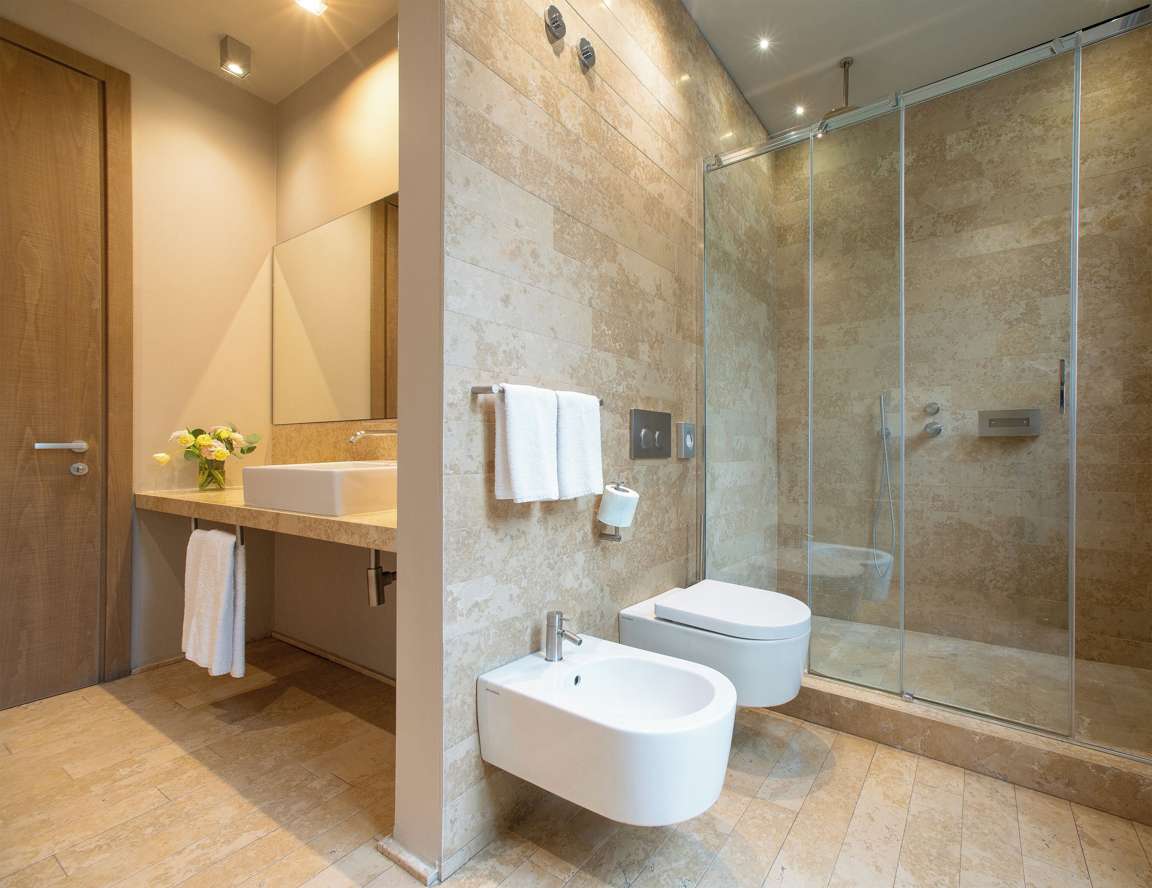 deluxe room | bathroom | shower, rainfall showerhead, designer toiletries, bidet