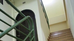 A staircase with green handrails and patterned tiles. - Bon Ca Va (Chiang Mai)