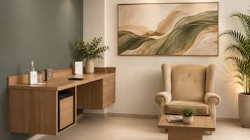 A modern interior with a wooden desk, a cushioned armchair, and a large abstract painting on the wall.