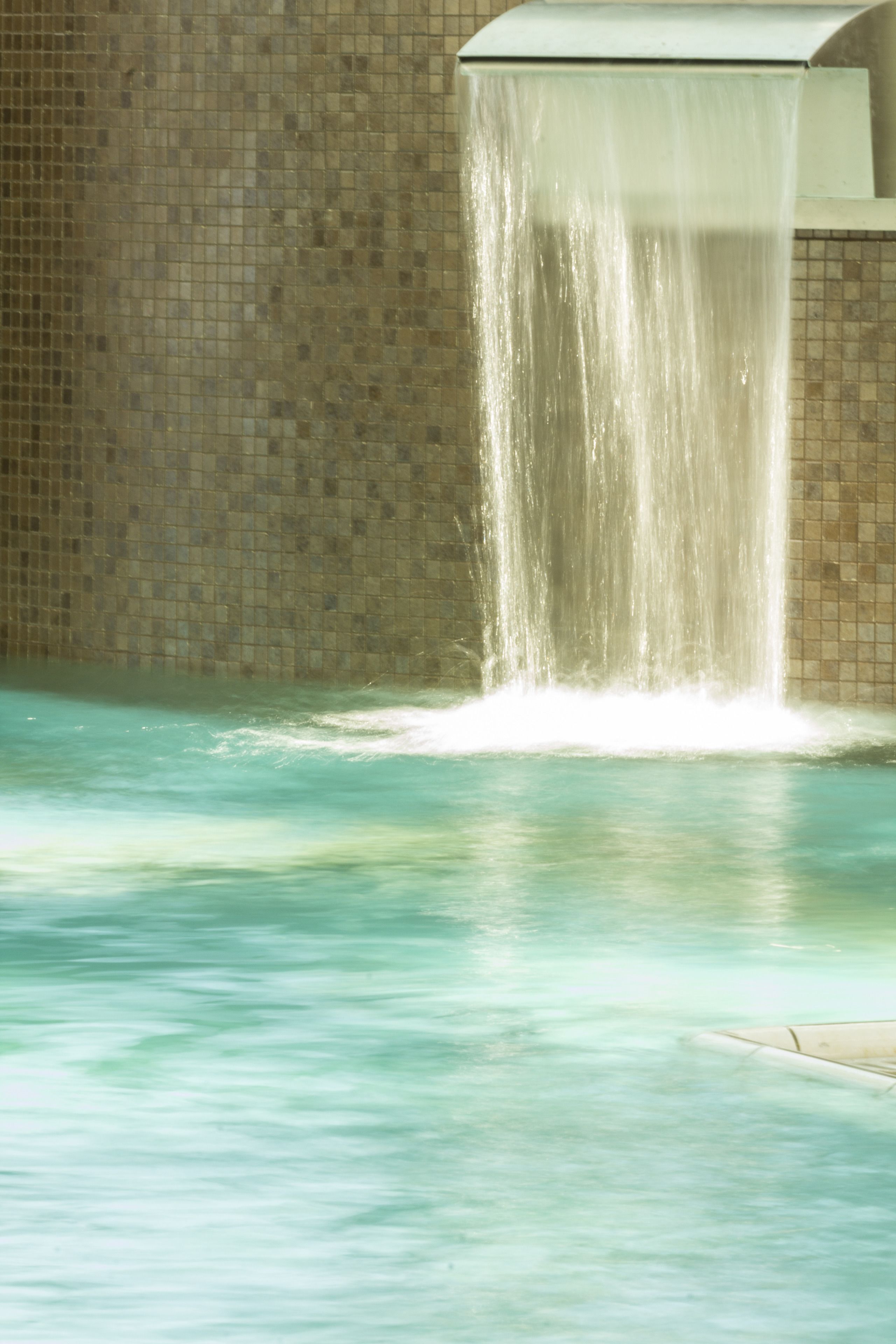 A pool with a waterfall feature.