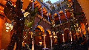 An indoor courtyard with arches, columns, and a central fountain. - Hotel Boutique Casa del Poeta Sevilla (Seville)