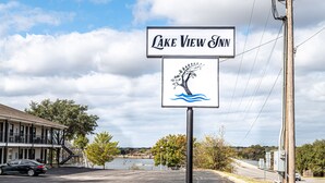 A sign for Lake View Inn with a tree and water graphic.