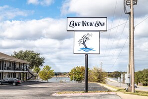 A sign for Lake View Inn with a tree and water graphic.