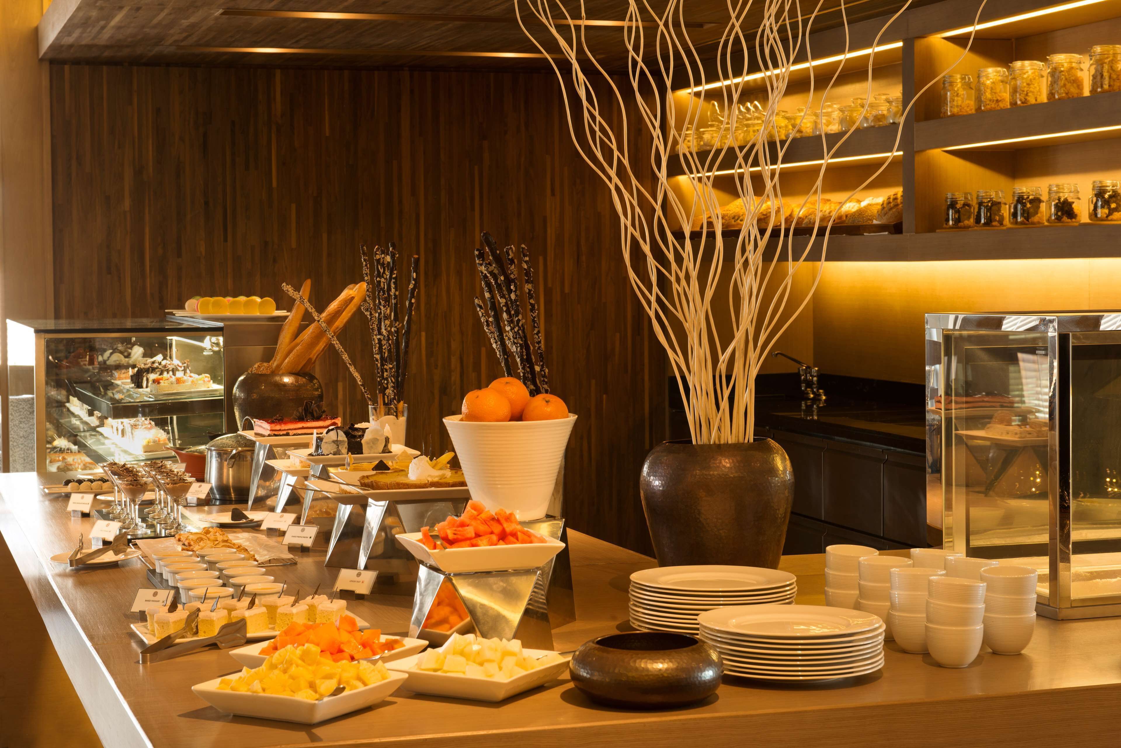 Una mesa de buffet con diversos alimentos y utensilios.