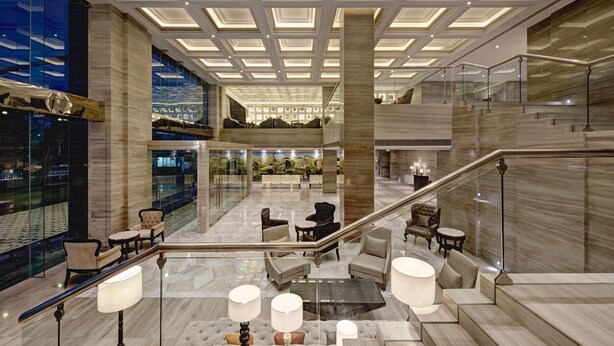 A spacious lobby with a high ceiling, marble flooring, and multiple seating areas. - Hyatt Regency Ludhiana (Ludhiana)