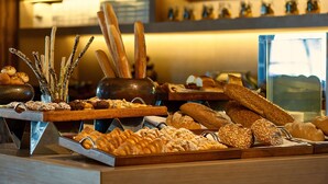 A variety of breads and pastries displayed on wooden trays. - Hyatt Regency Ludhiana (Ludhiana)