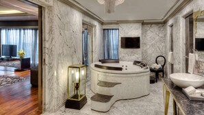 A luxurious bathroom with a freestanding bathtub, a large sink, and marble walls. - Hyatt Regency Ludhiana (Ludhiana)