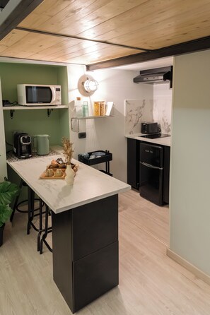 A modern kitchen with a central island, a microwave, a coffee maker, and a toaster. - City Life Rome (Rome)