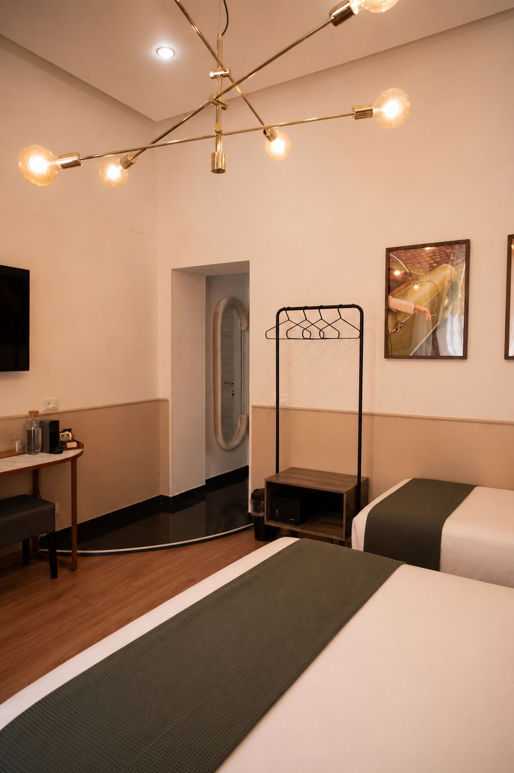 A hotel room with a bed, bedside table, and a hanging light fixture.