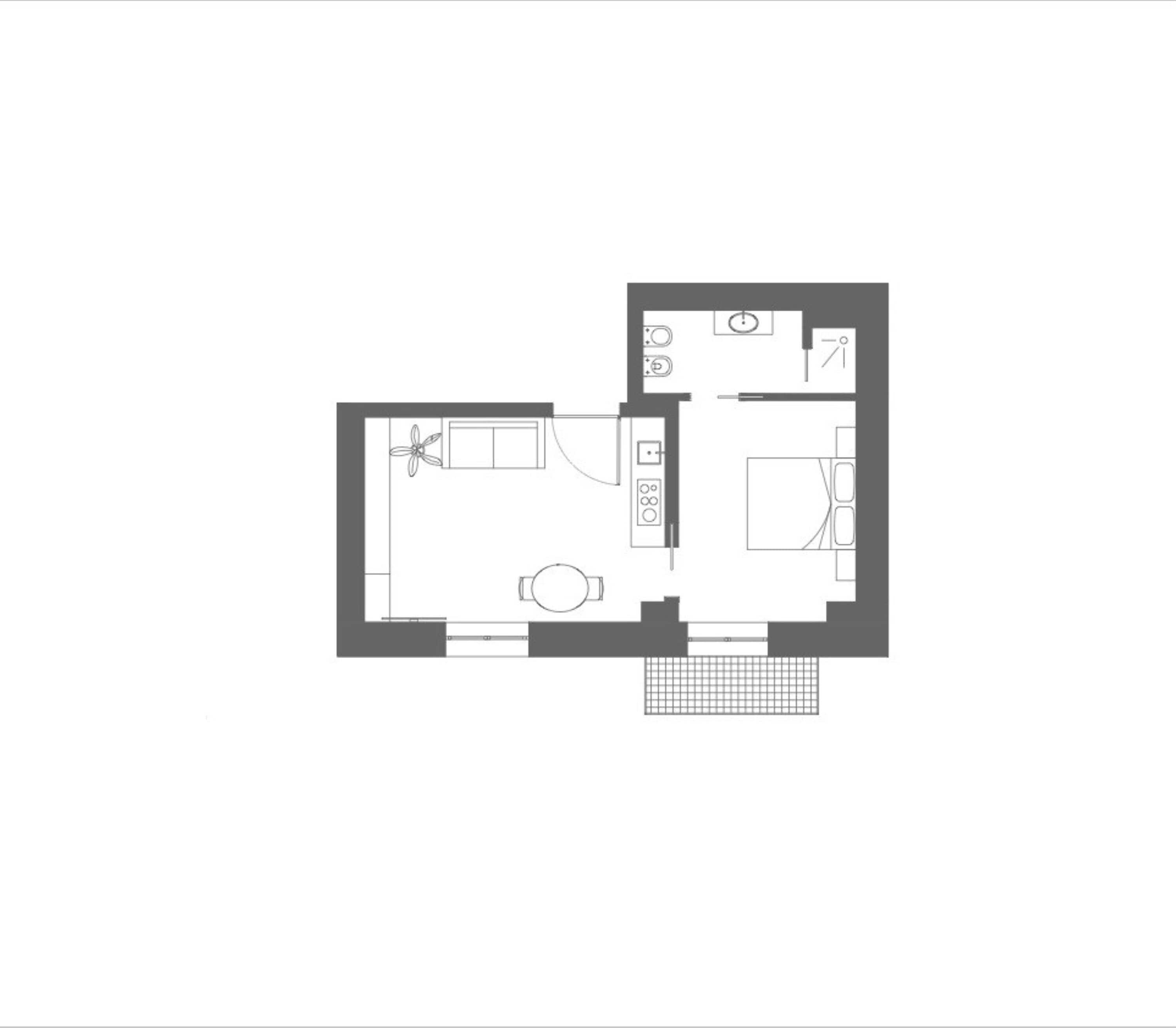 A floor plan of a hotel room with a kitchenette, a bathroom, and a small seating area.