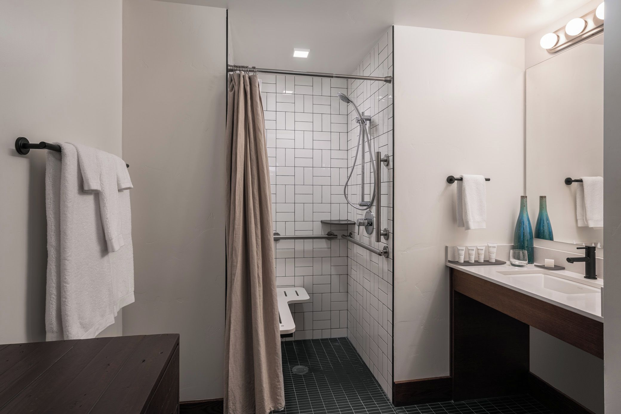 A modern bathroom with a shower, toilet, and vanity.