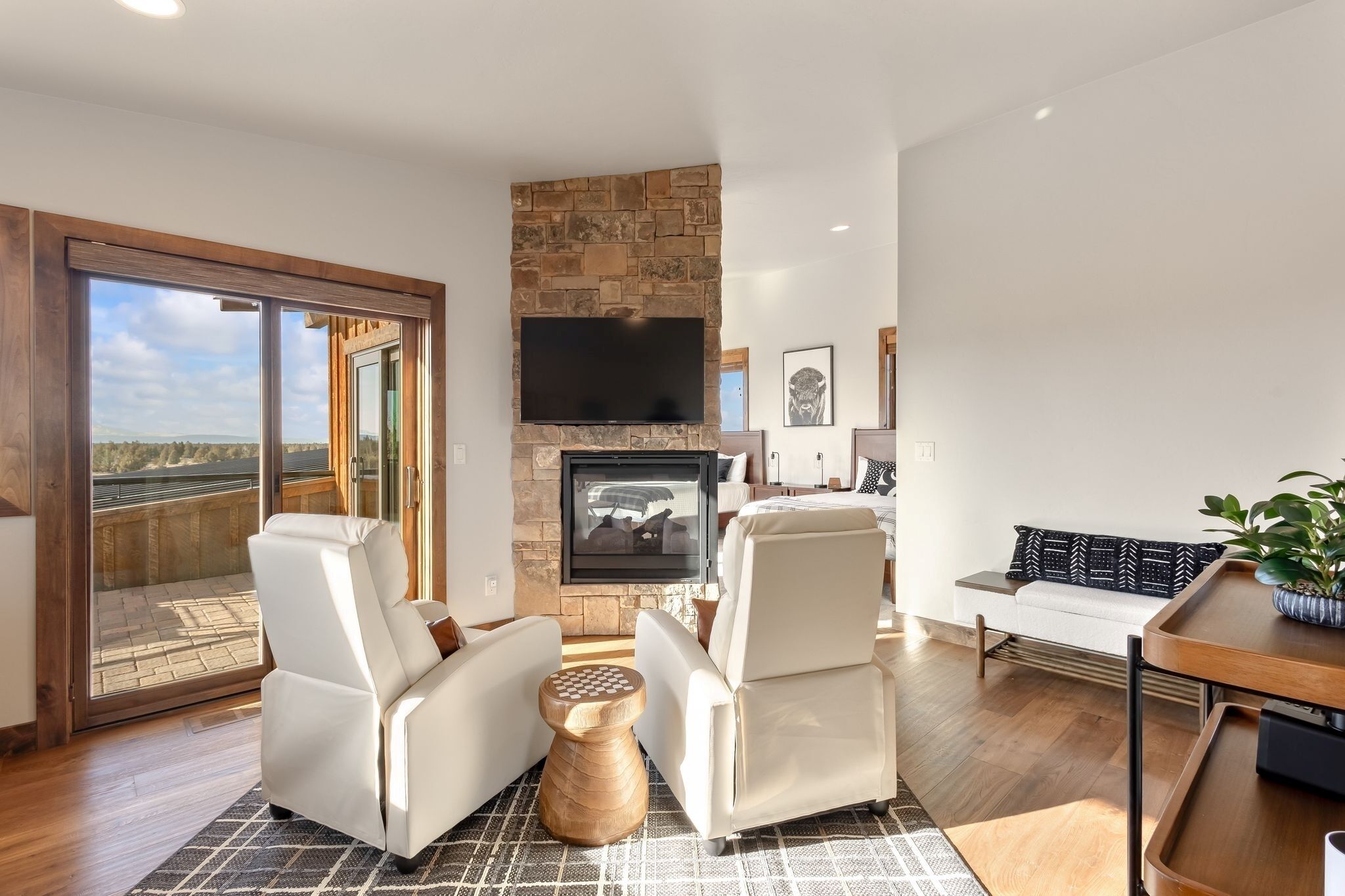 A modern living room with a fireplace, a television, and a sofa.