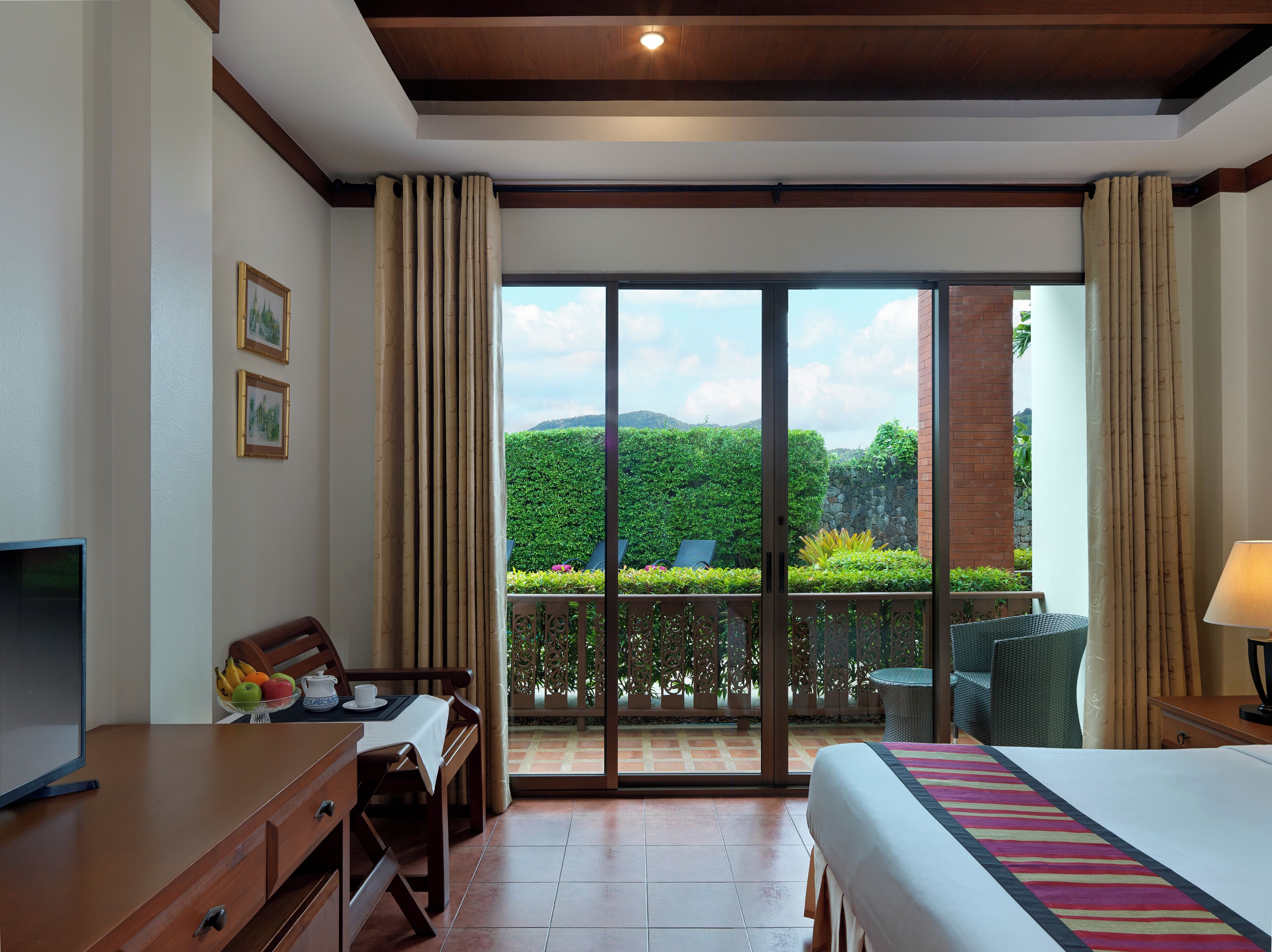 deluxe double or twin room, pool view | free minibar items, in-room safe, desk, laptop workspace