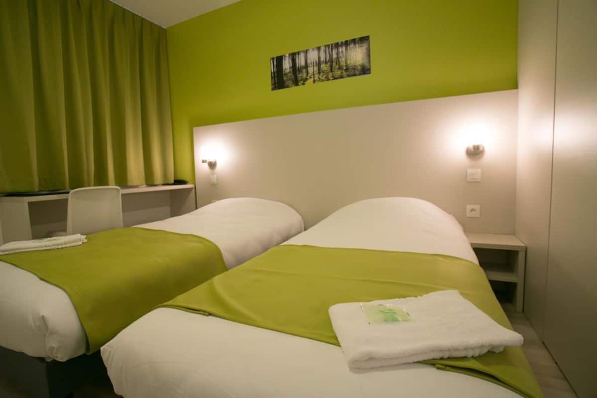 twin room | premium bedding, desk, blackout curtains, soundproofing