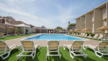 Piscine extérieure, parasols de plage, chaises longues