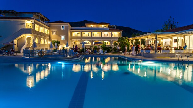 A swimming pool with a reflection of the building and surrounding area. - Klelia Beach Hotel - All Inclusive (Zakynthos)