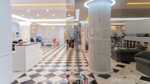 A lobby with a check-in counter, a large pillar, and a patterned floor. - Klelia Beach Hotel - All Inclusive (Zakynthos)