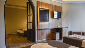 A hotel room with two beds, a small desk, a television, and a mirror. - Fatih Hotel Kleopatra (Alanya)