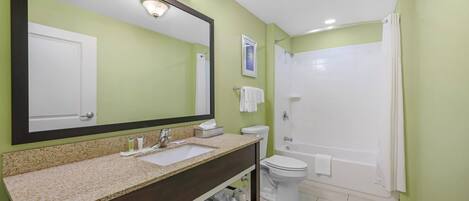 A bathroom with a sink, toilet, and shower.