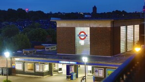 A subway station with a prominent 'Underground' sign, a brick building, and a covered waiting area with benches and information boards. -  Best Western Northfields Ealing Hotel-Opposite Northfield Station -Piccadilly line (London)