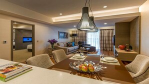 A modern hotel room with a dining area, a living room, and a TV in the corner. - Ascott Sentral Kuala Lumpur (Kuala Lumpur)