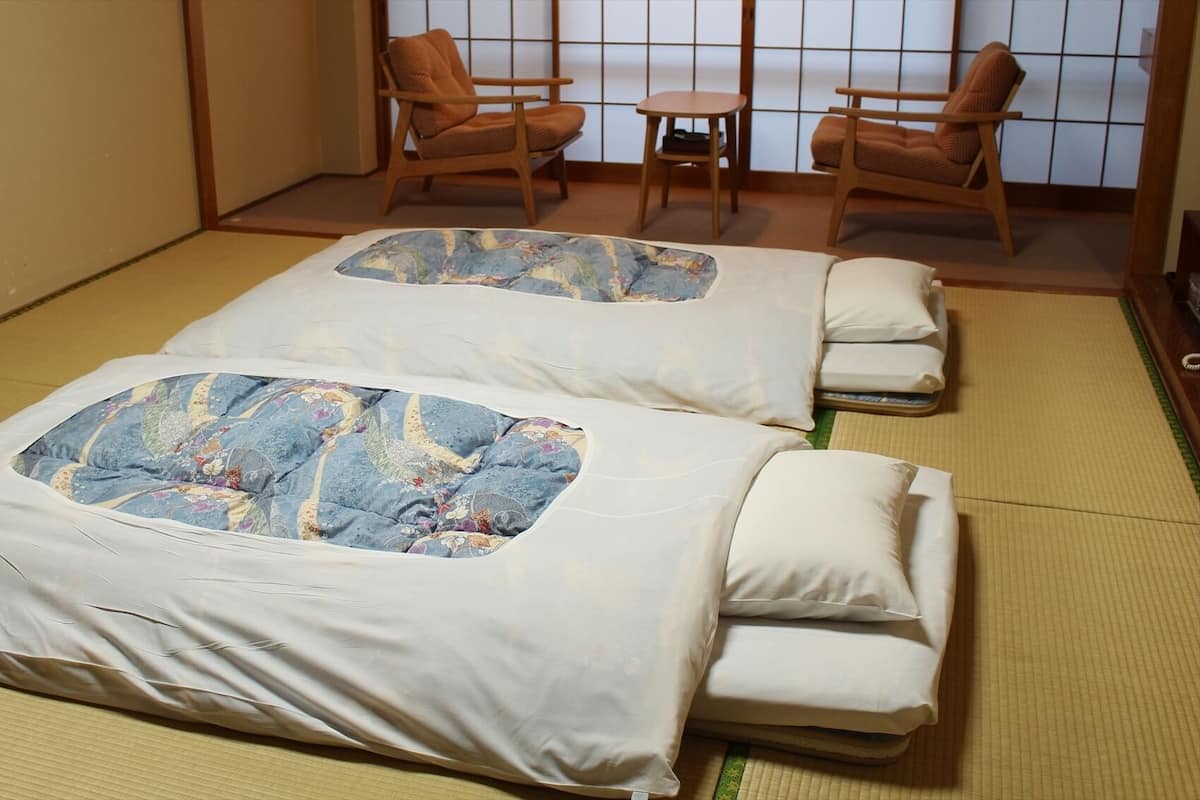 Two tatami mat rooms with wooden furniture and shoji screens.