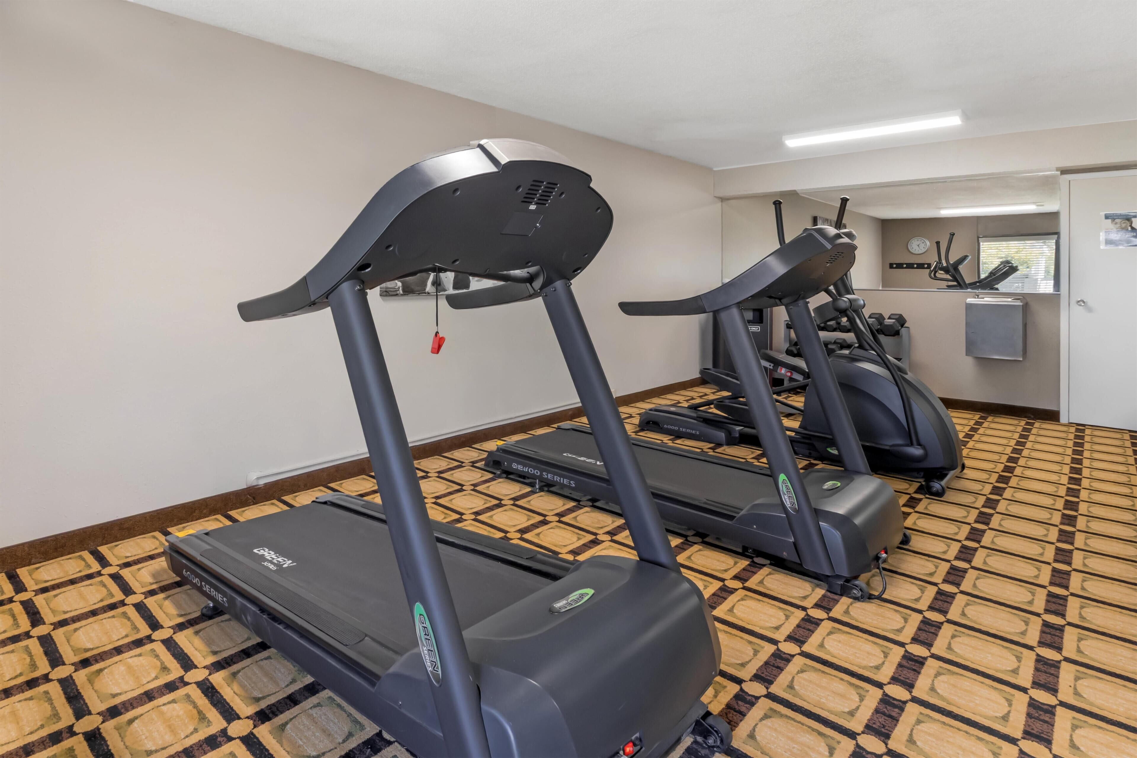A gym area with treadmills and exercise equipment.
