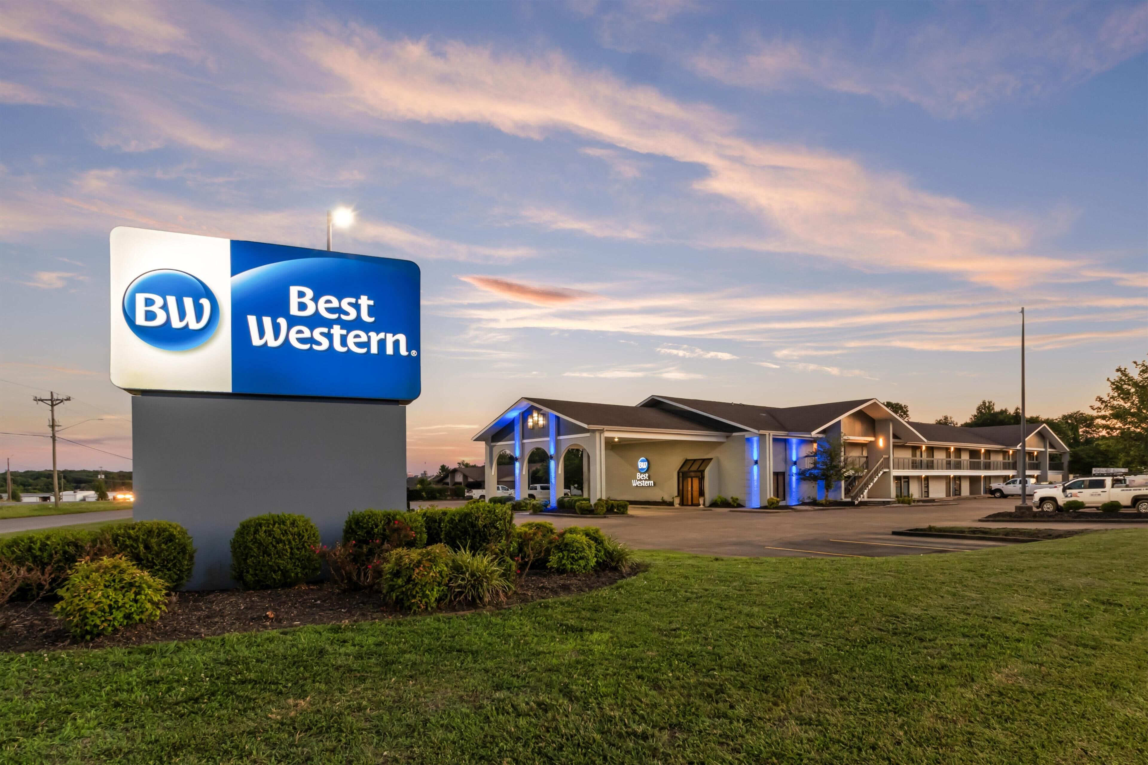 A Best Western hotel with a prominent sign, a parking lot, and a building with a covered entrance.