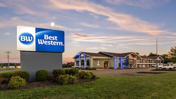 A Best Western hotel with a prominent sign, a parking lot, and a building with a covered entrance.