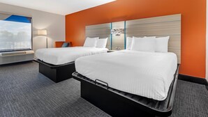 A hotel room with two beds, a large window, and a view of the outdoors. - Best Western University Inn (Murray)