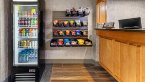 A vending machine with snacks and a refrigerator with beverages. - Best Western University Inn (Murray)