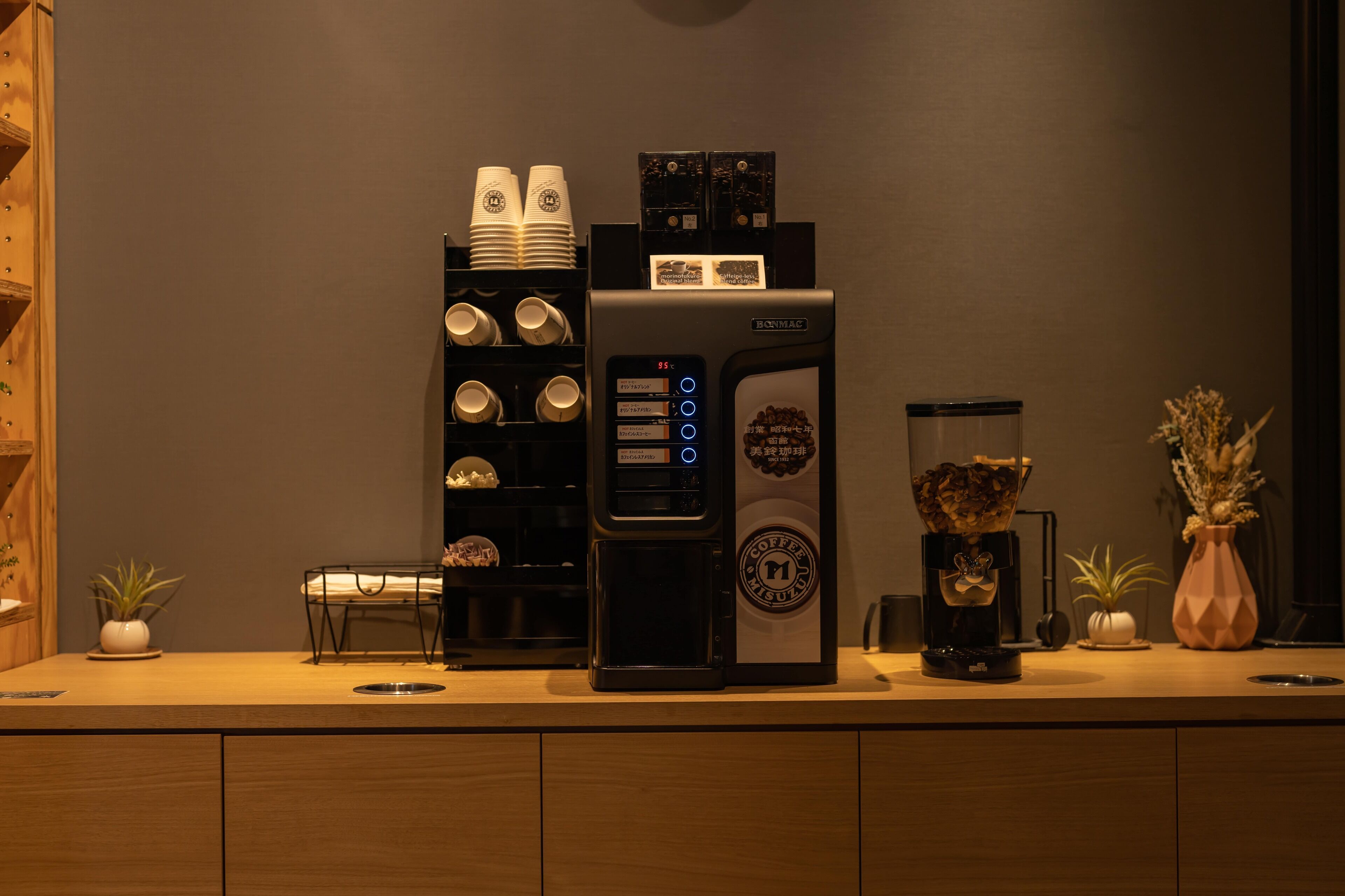 A coffee machine with multiple cup options and a coffee dispenser on a counter.