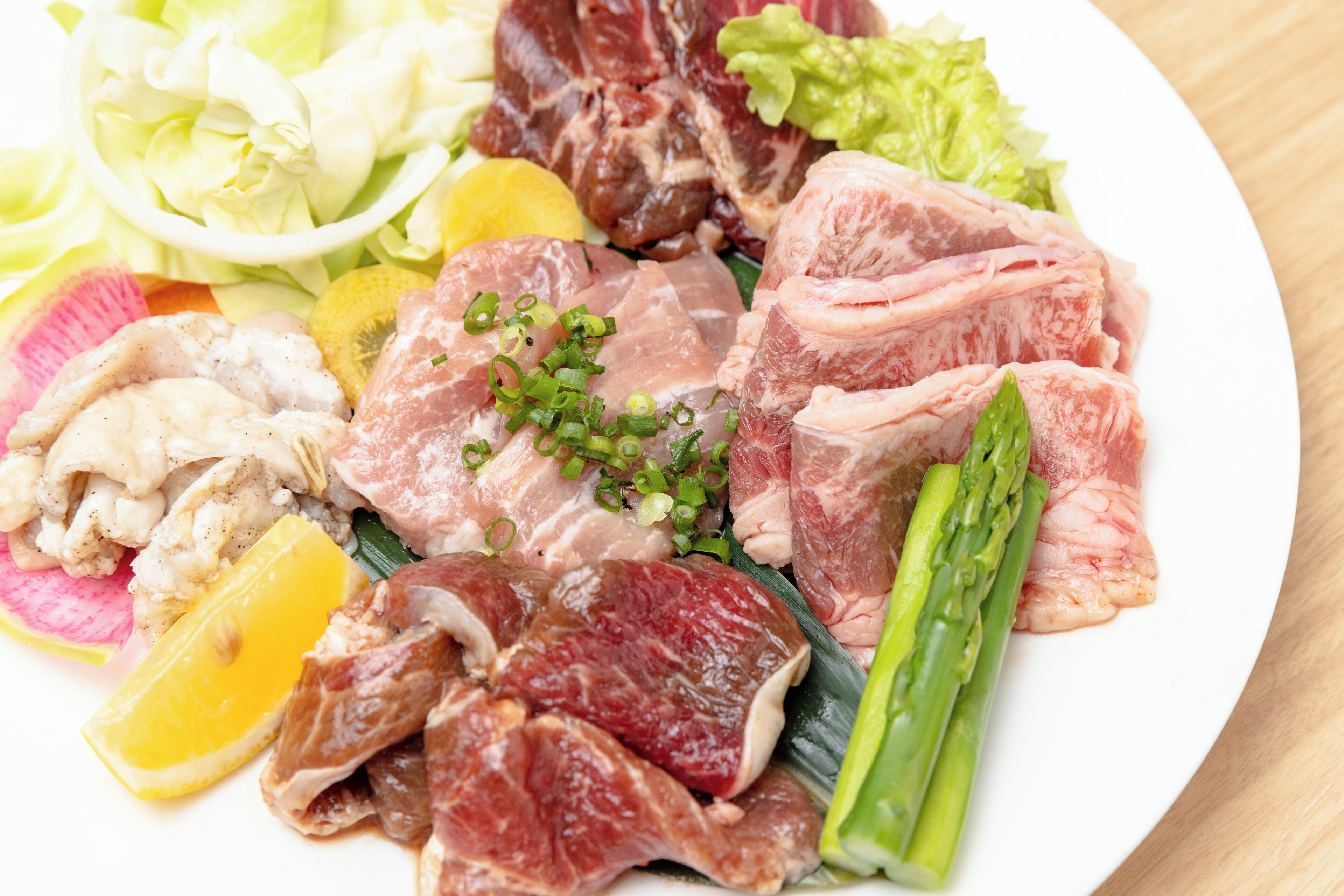 A plate of assorted meats and vegetables.