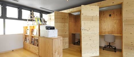 A modern office space with wooden walls, a reception desk, and office chairs.