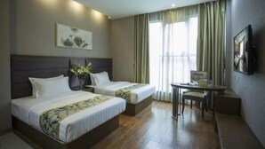 A hotel room with two beds, a desk, and a chair. There is a painting on the wall and a window with curtains. - GreenTree Inn Taizhou Gaogang District Gov. Business Hotel (Taizhou)
