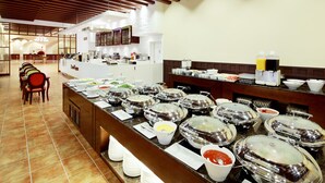 A buffet setup with multiple food stations and a seating area with chairs. - Hanwha Resort Seorak Sorano (Sokcho)