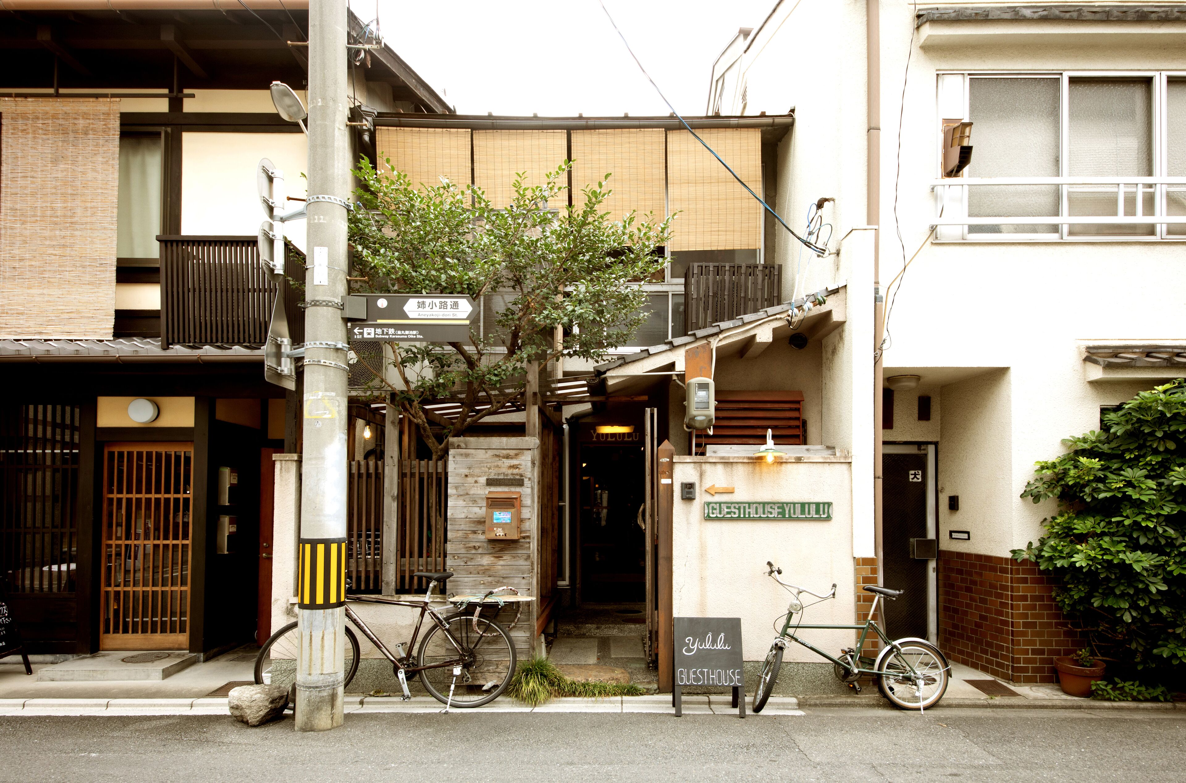 A building with a sign reading "YUKUYA GUESTHOUSE".