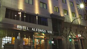 A multi-story hotel building with illuminated windows and a sign reading "HOTEL ALFONSO VIII". - Alfonso VIII (Soria)
