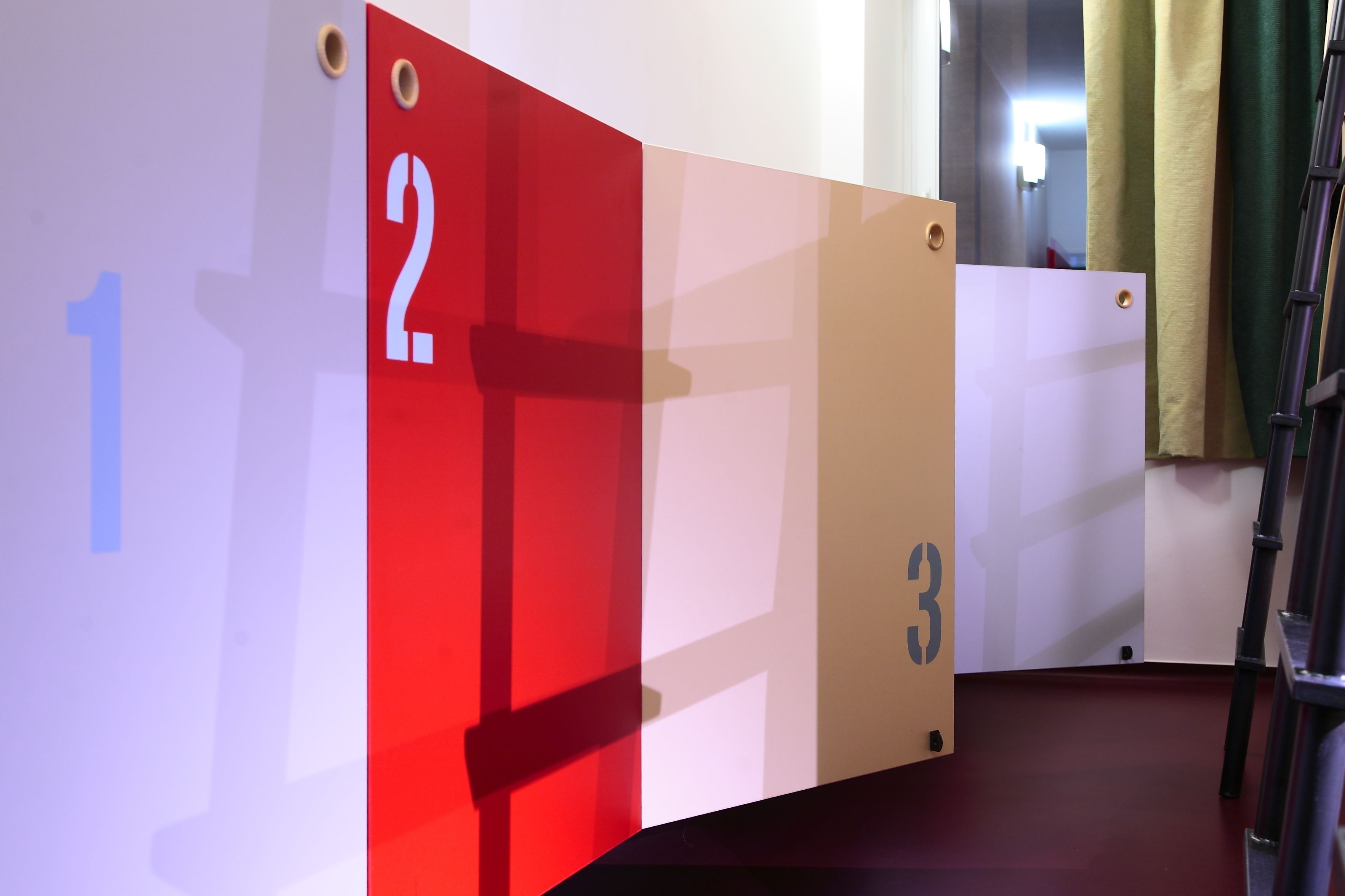 A room with numbered partitions, a ladder, and a door.