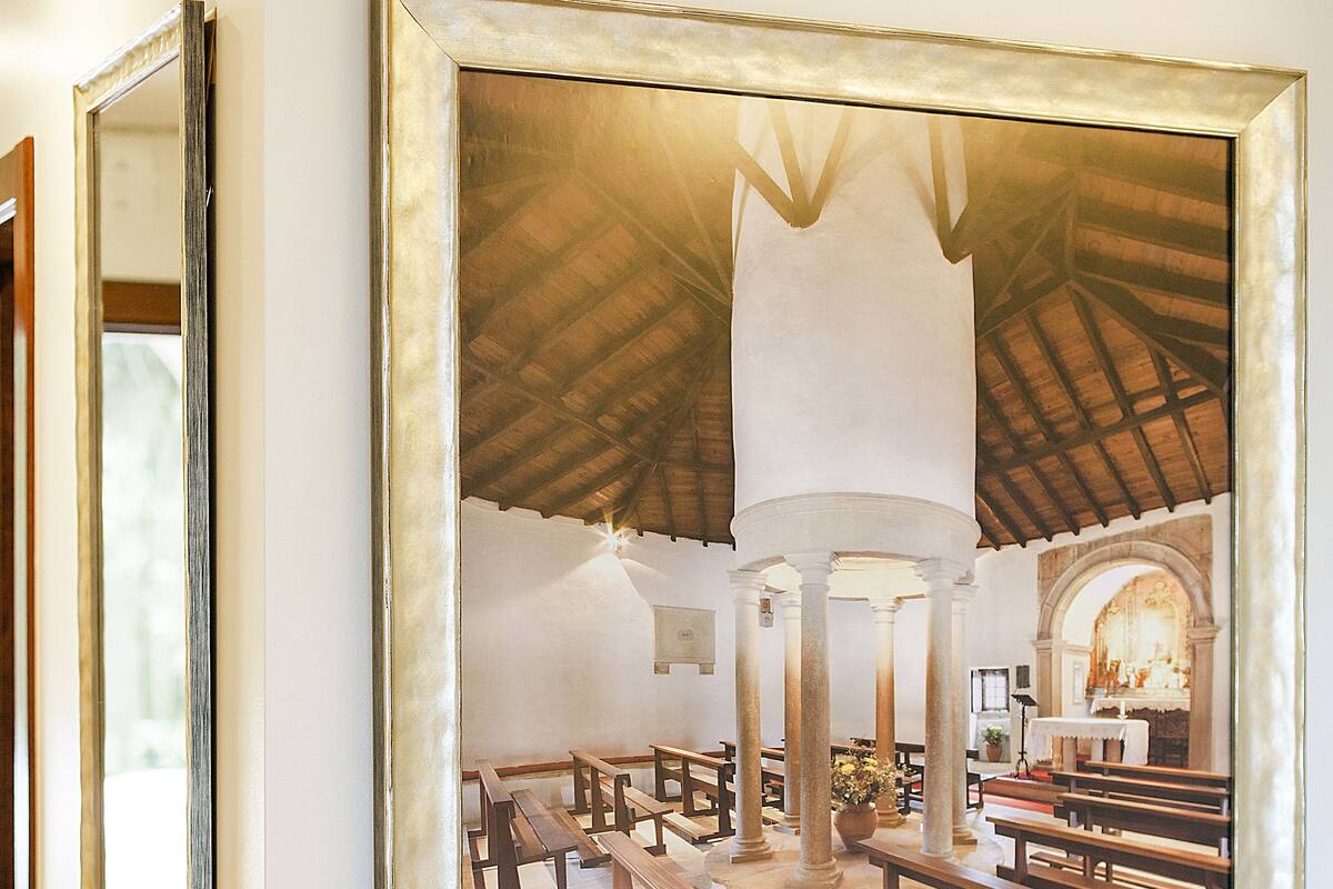 A framed photograph of a church interior with pews and a central aisle.