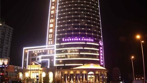 A multi-story hotel with illuminated signage and a prominent entrance. - GreenTree Huainan Tianjiaan Square Guangchang road Hotel (Huainan)