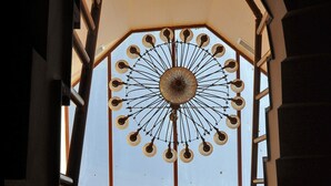 A large, circular window with a decorative metal frame and a central circular design. - Alfa Hotel (Istanbul)