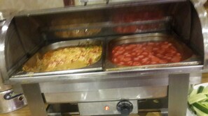 A buffet with two trays of food, one with a yellowish dish and the other with red kidney beans. - Alfa Hotel (Istanbul)